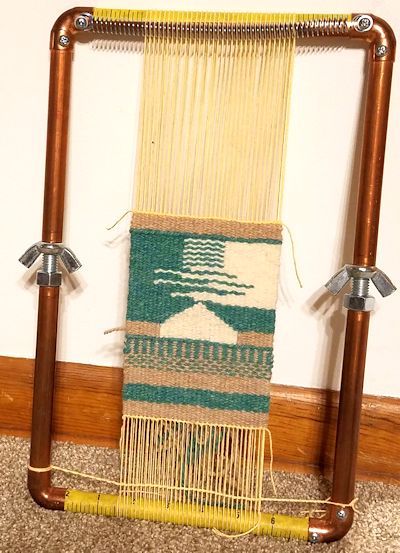 Small tapestry weaving on the loom