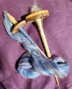 Two spindles with blue roving